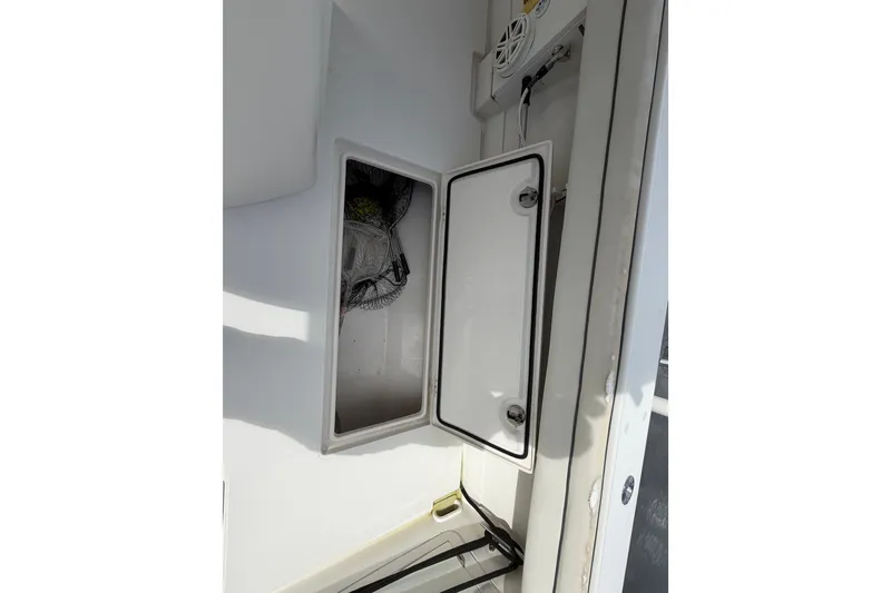 Slide: The Image of Open storage compartment on a 2014 Jupiter 34 FS boat, showcasing interior space. - 15
