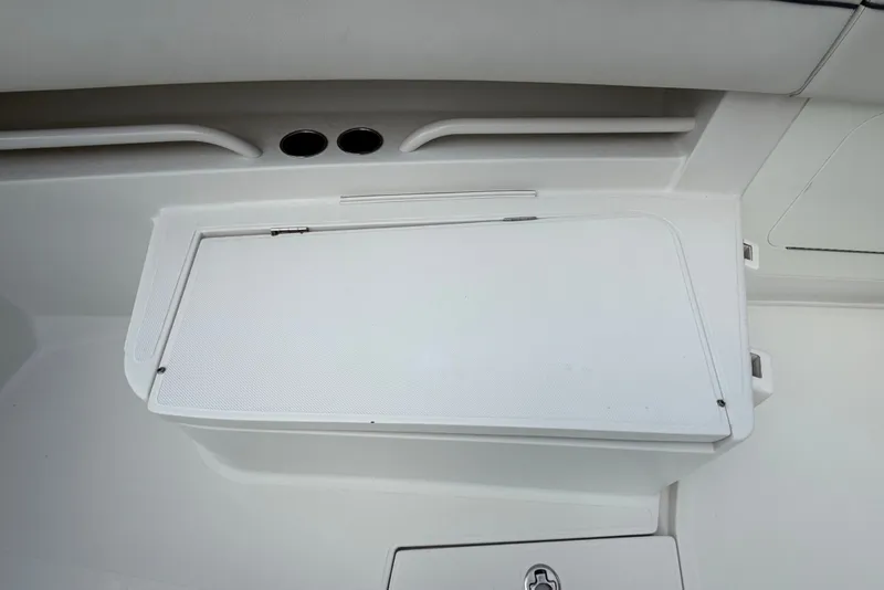 Slide: The Image of 2014 Jupiter 34 FS boat storage compartment with white lid and sleek design. - 58