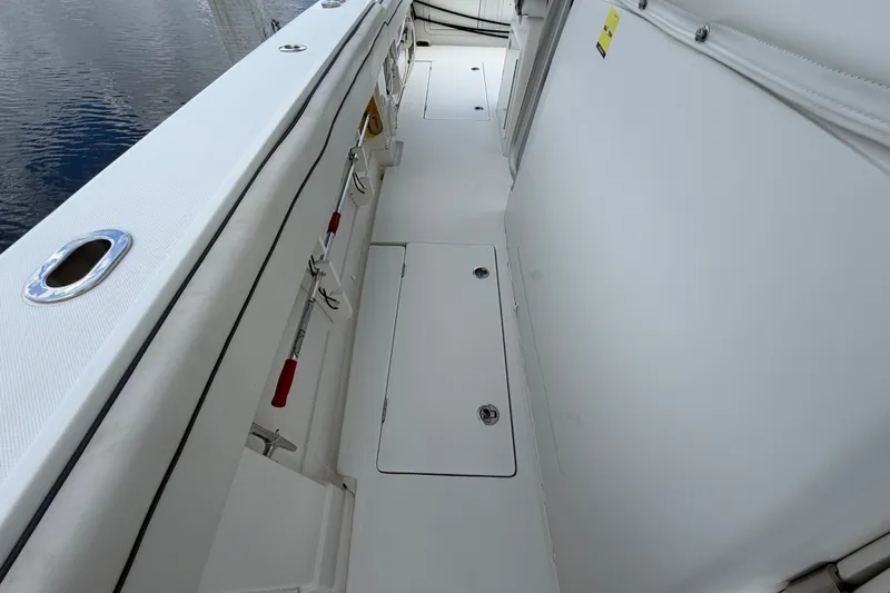 Slide: The Image of 2014 Jupiter 34 FS boat deck with storage compartments and fishing rod holders. - 49