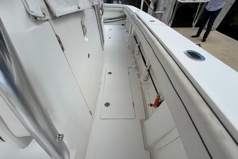 Slide: The Image of 2014 Jupiter 34 FS boat deck with rod holders and storage compartments. - 51