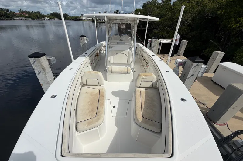 Slide: The Image of 2014 Jupiter 34 FS boat docked, featuring spacious seating and sleek design. - 68