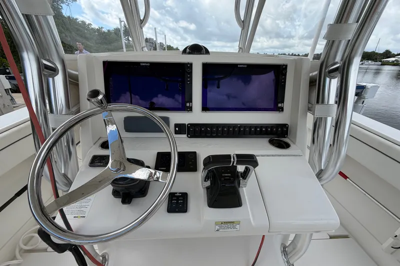 Slide: The Image of Helm of 2014 Jupiter 34 FS boat with dual Simrad displays and Yamaha controls. - 24