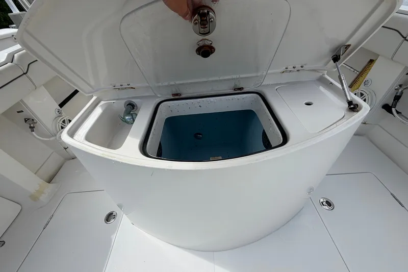 Slide: The Image of Open storage compartment on a 2014 Jupiter 34 FS boat, showcasing interior features. - 21