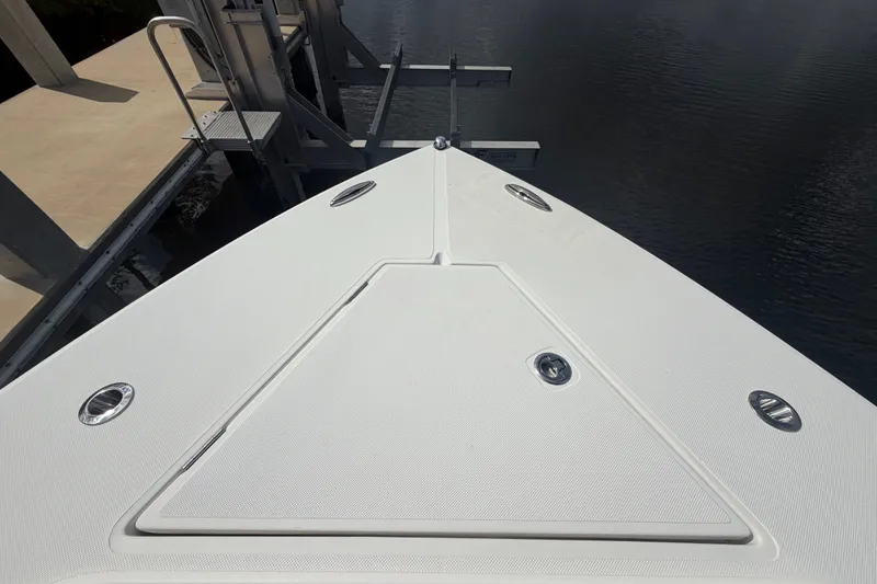 Slide: The Image of Bow view of a 2014 Jupiter 34 FS boat docked by the water. - 65