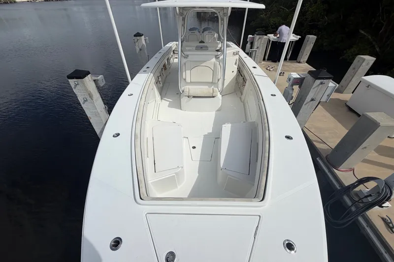 Slide: The Image of 2014 Jupiter 34 FS boat docked, showcasing spacious deck and seating area. - 69