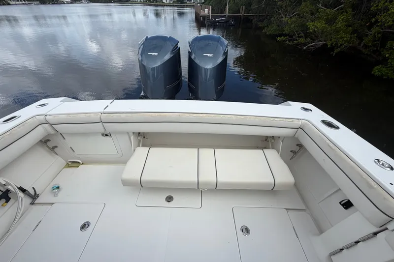 Slide: The Image of 2014 Jupiter 34 FS boat with twin outboard motors on calm water. - 9