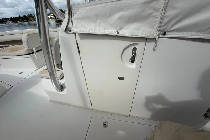 Slide: The Image of 2014 Jupiter 34 FS boat interior with white seating and storage compartment. - 53