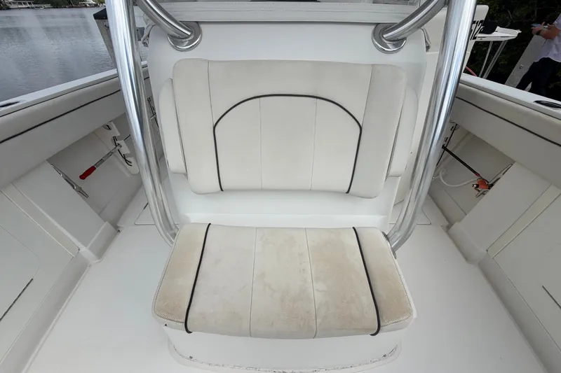 Slide: The Image of 2014 Jupiter 34 FS boat interior with white cushioned seating and stainless steel supports. - 75