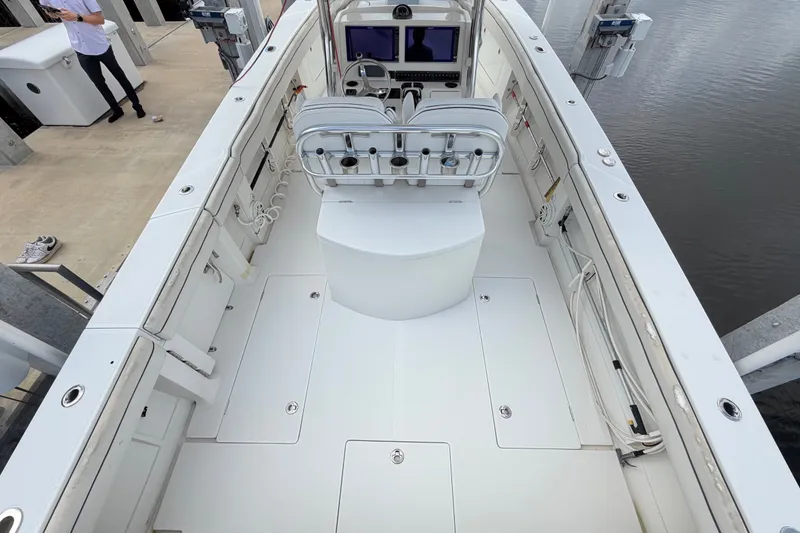 Slide: The Image of 2014 Jupiter 34 FS boat interior with helm station and seating, docked by the water. - 11