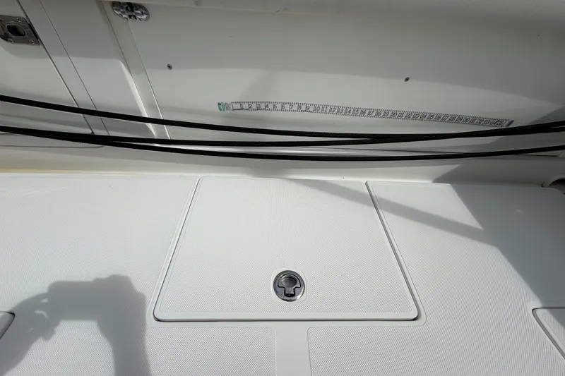 Slide: The Image of 2014 Jupiter 34 FS boat deck with storage hatch and measuring tape. - 16