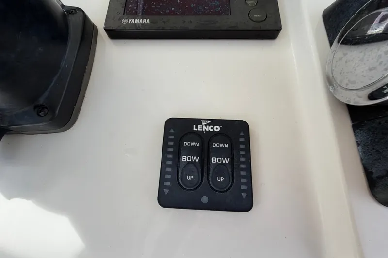 Slide: The Image of Control panel of a 2014 Jupiter 34 FS boat with Lenco trim tab switches. - 28