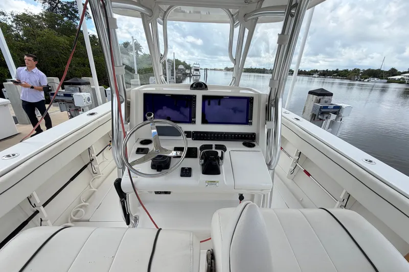 Slide: The Image of 2014 Jupiter 34 FS boat cockpit with steering wheel and navigation screens. - 22
