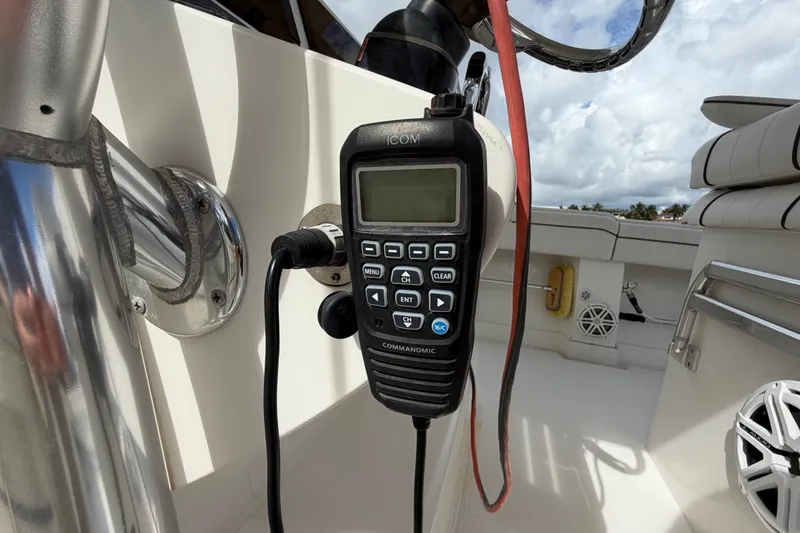 Slide: The Image of ICOM marine radio on a 2014 Jupiter 34 FS boat deck, with clear sky background. - 32