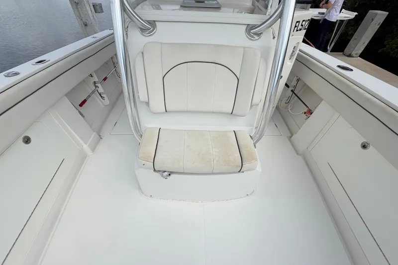 Slide: The Image of 2014 Jupiter 34 FS boat interior with white seating and storage compartments. - 73
