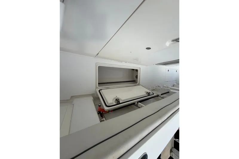 Slide: The Image of Open storage compartment on a 2014 Jupiter 34 FS boat interior. - 52