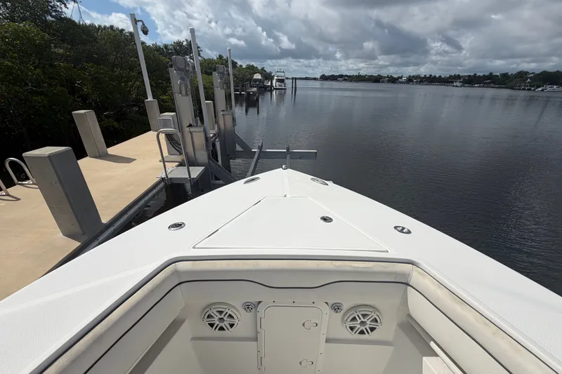 Slide: The Image of Bow view of 2014 Jupiter 34 FS boat docked by a serene waterfront. - 64