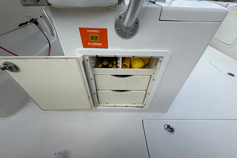 Slide: The Image of Storage compartment on a 2014 Jupiter 34 FS boat with Florida registration sticker. - 83