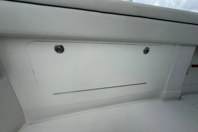 Slide: The Image of 2014 Jupiter 34 FS boat storage compartment with secure latches and sleek design. - 44