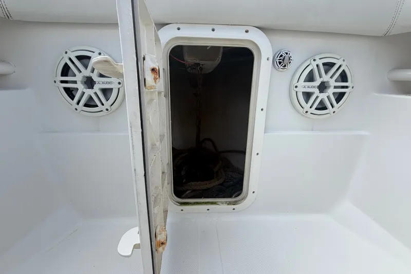 Slide: The Image of Open storage compartment on 2014 Jupiter 34 FS boat with JL Audio speakers. - 63