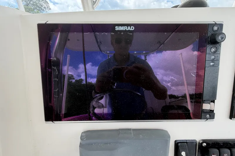 Slide: The Image of Simrad display on 2014 Jupiter 34 FS boat, reflecting sky and surroundings. - 26