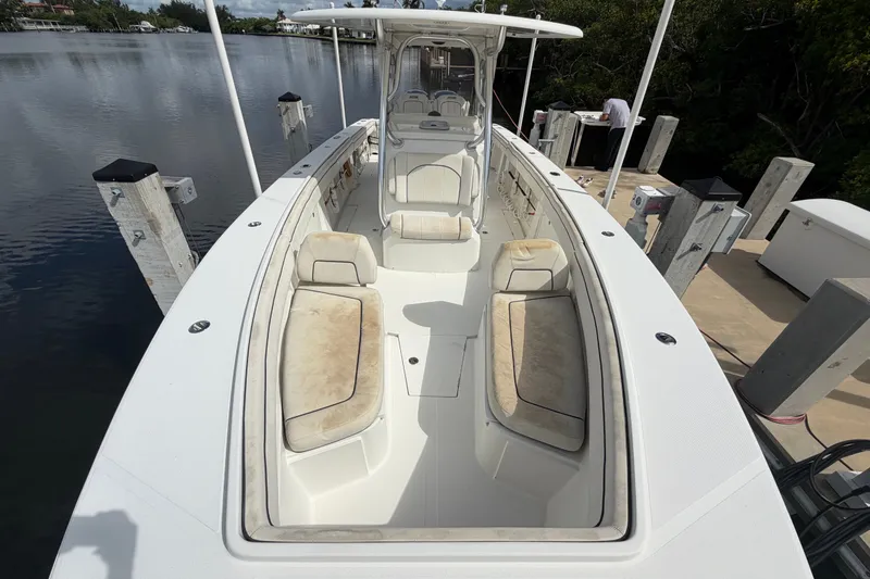 Slide: The Image of 2014 Jupiter 34 FS boat docked, featuring spacious seating and sleek design. - 67