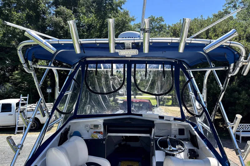 Slide: The Image of 1978 B&D 24 Cuddy boat with blue canopy and fishing rod holders. - 6
