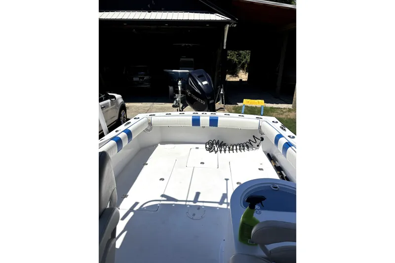 Slide: The Image of 1978 B&D 24 Cuddy boat interior with Tohatsu engine, parked in a garage. - 8