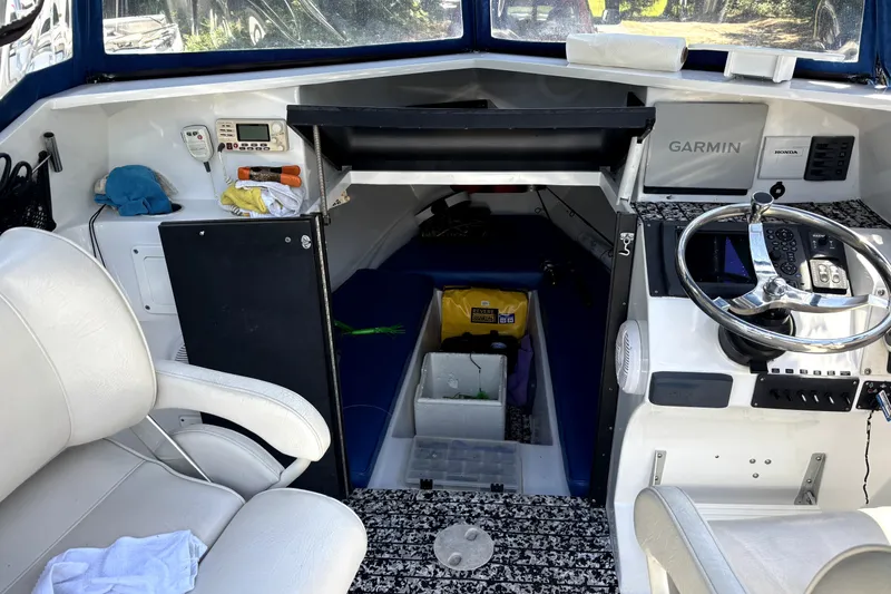 Slide: The Image of Interior of a 1978 B&D 24 Cuddy boat with steering wheel and navigation equipment. - 7