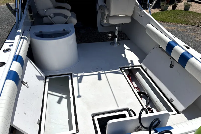 Slide: The Image of 1978 B&D 24 Cuddy boat interior with open storage compartments and seating. - 9