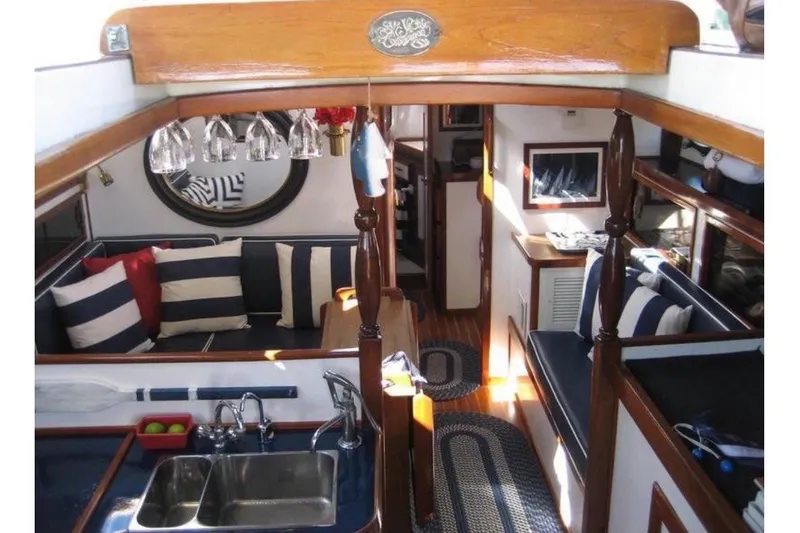 Slide: The Image of Interior of a 1978 CSY 37 with a cozy salon, striped cushions, and wooden accents. - 4
