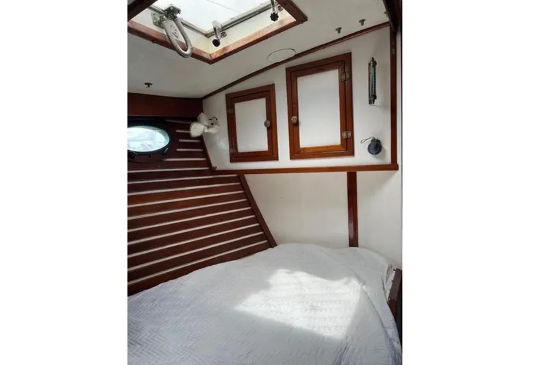 Slide: The Image of Interior of a 1978 CSY 37 with wooden walls and a bed under a skylight. - 6