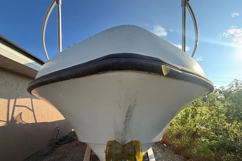 Slide: The Image of 1977 Mako 235 boat bow, white hull, outdoor setting, sunny day. - 9