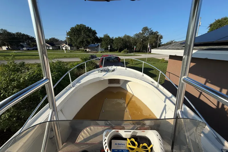 Slide: The Image of 1977 Mako 235 boat interior view, parked outdoors on a sunny day. - 31