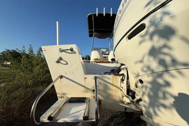 Slide: The Image of 1977 Mako 235 boat with swim platform and canopy, parked outdoors. - 6