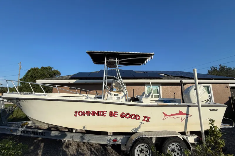 Slide: The Image of 1977 Mako 235 boat named "Johnnie Be Good II" on trailer, sunny day. - 1