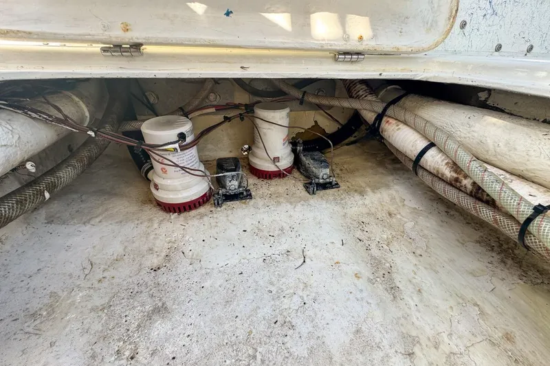Slide: The Image of 1972 Cuda Craft Open Fisherman boat bilge area with pumps and hoses. - 67