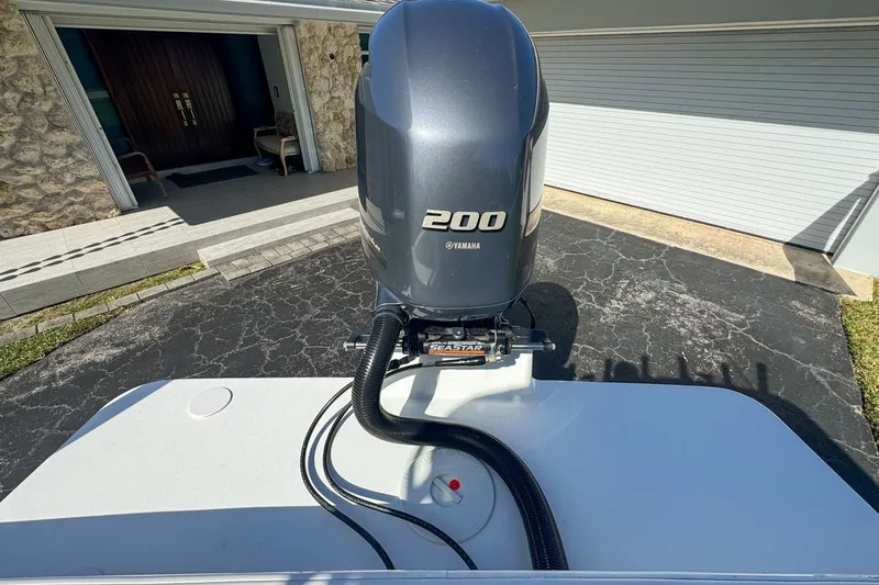 Slide: The Image of 1972 Cuda Craft Open Fisherman with Yamaha 200 outboard motor in driveway. - 73