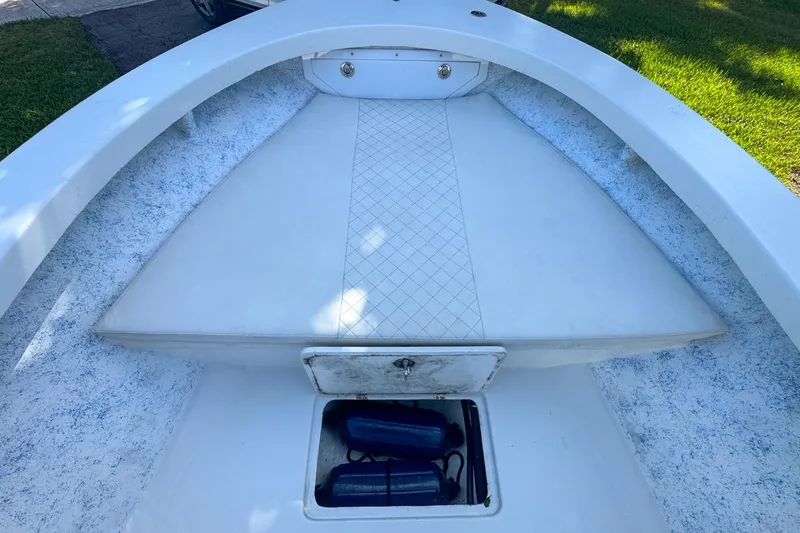 Slide: The Image of 1972 Cuda Craft Open Fisherman boat interior with storage compartment and cushioned seating. - 34