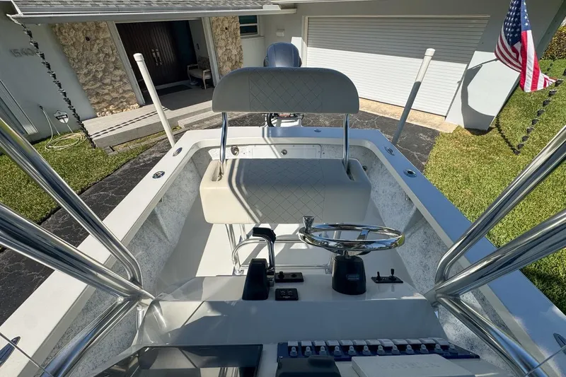 Slide: The Image of 1972 Cuda Craft Open Fisherman boat with steering wheel and controls, parked near a house. - 59