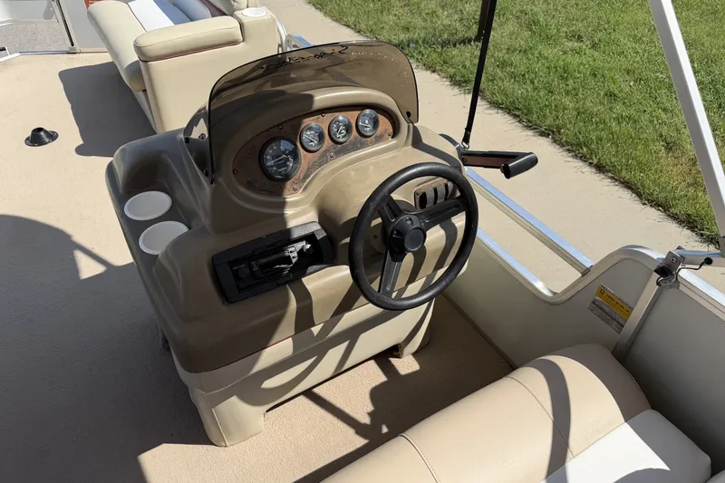 Slide: The Image of 1997 Sun Tracker Party Barge 21 Signature Series helm with steering wheel and gauges. - 21