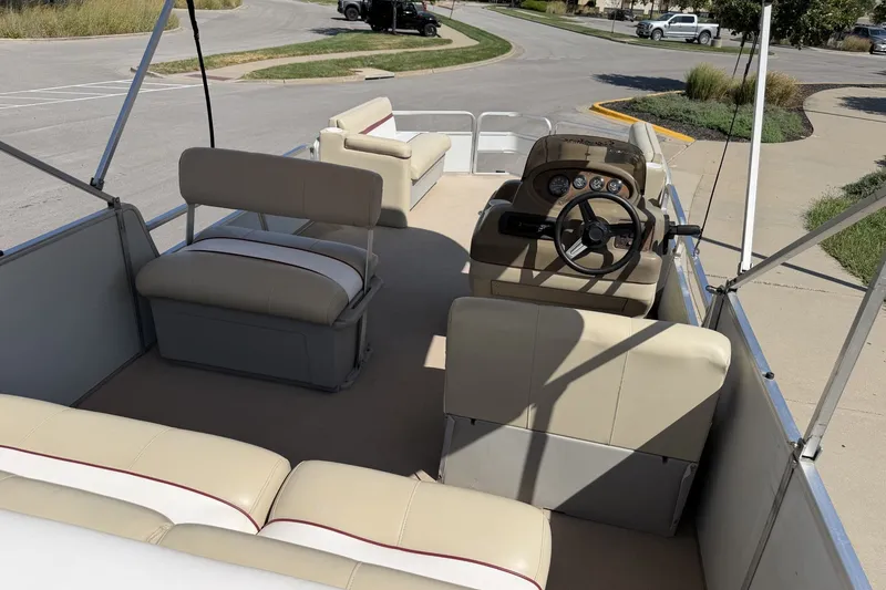 Slide: The Image of 1997 Sun Tracker Party Barge 21 Signature Series pontoon boat with beige seating and steering console. - 18