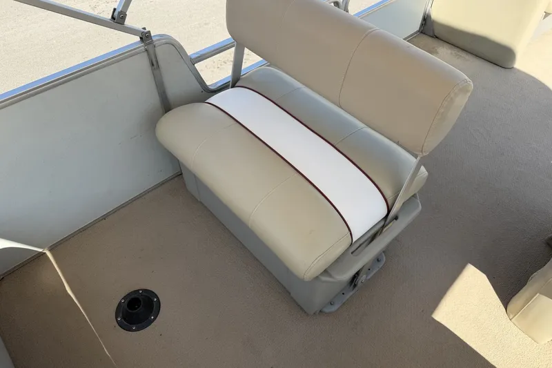 Slide: The Image of 1997 SUNTRACKER Party Barge 21 interior with beige seating and carpeted floor. - 13