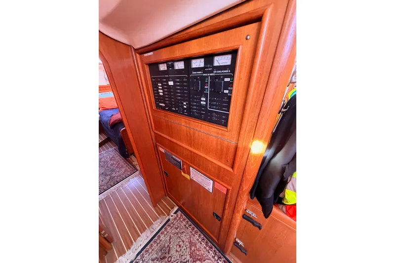 Slide: The Image of Interior view of 2005 Hunter Passage 456 yacht showing control panel and wooden cabinetry. - 46