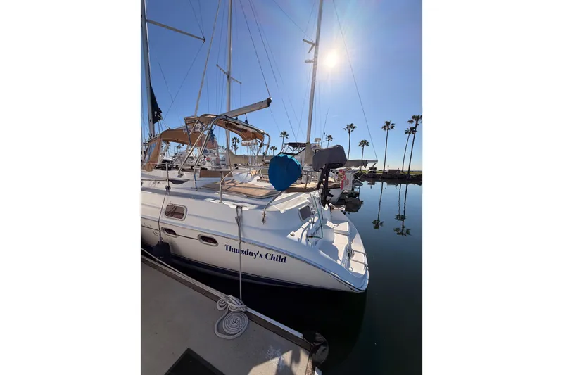 Slide: The Image of Sailboat "Thursday's Child" docked, Hunter Passage 456, 2005 model, sunny marina setting. - 8