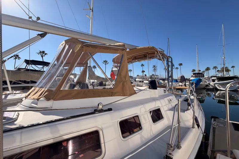 Slide: The Image of 2005 Hunter Passage 456 sailboat docked in marina under clear blue sky. - 7