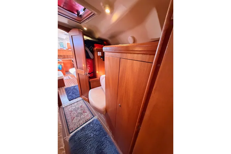 Slide: The Image of Interior of 2005 Hunter Passage 456 yacht with wooden cabinetry and cozy seating. - 62