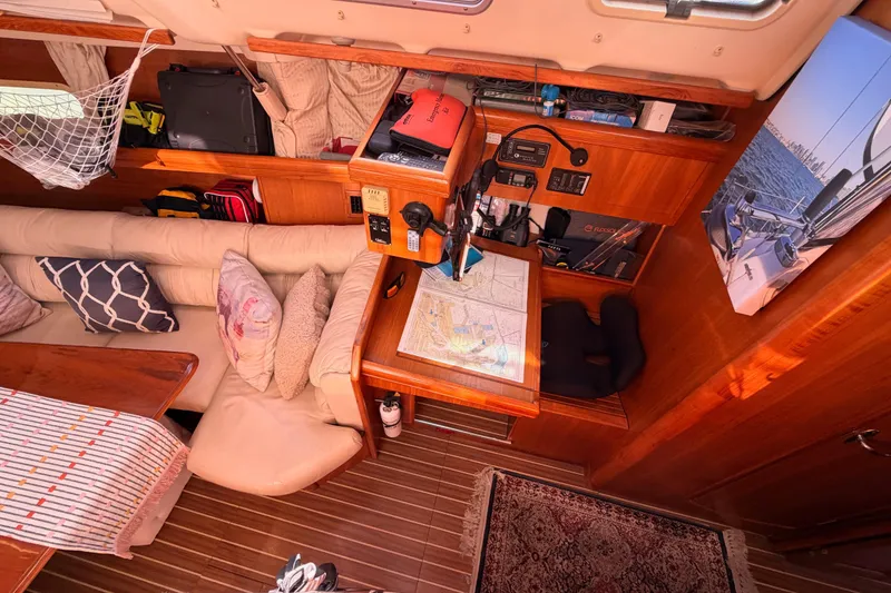 Slide: The Image of Interior of 2005 Hunter Passage 456 sailboat with navigation station and cozy seating area. - 34