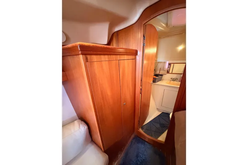 Slide: The Image of Interior of 2005 Hunter Passage 456 yacht showing wooden cabinetry and bathroom entrance. - 58