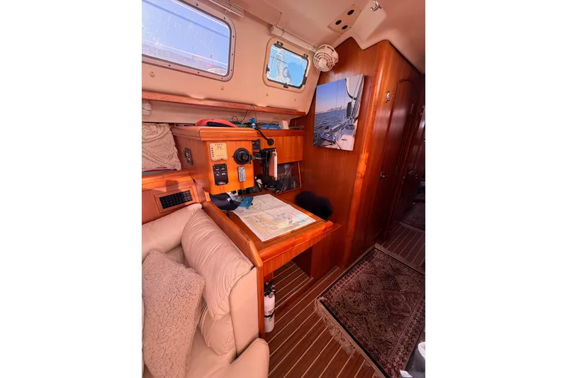 Slide: The Image of Interior of 2005 Hunter Passage 456 yacht with navigation station and cozy seating. - 44