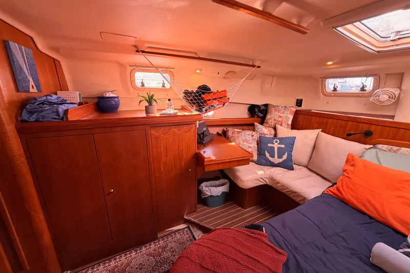 Slide: The Image of Cozy interior of 2005 Hunter Passage 456 sailboat with wooden cabinets and nautical decor. - 72
